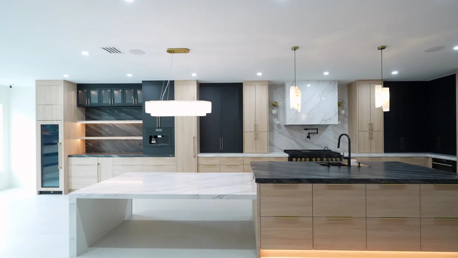 Luxury remodeled Houston kitchen with custom cabinetry and marble island